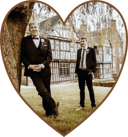 Two members of a wedding party outside the hall